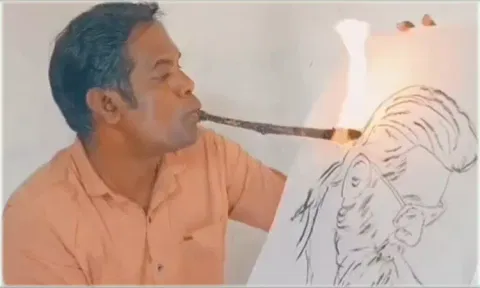 வாயில் நெருப்புடன் கூடிய குச்சியை பிடித்தபடி அஜித்தை வரைந்த ஓவியர்