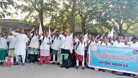Nurses raise slogans at the entrance of PHC
