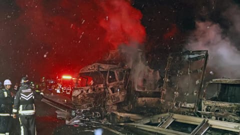 Burnt vehicles are seen after a massive crash in snowy weather on an expressway, in Minakami, northwest of Tokyo, early Saturday