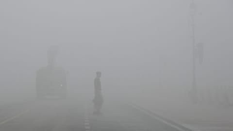 Fog covers the road making it difficult for people to travel.