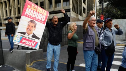 Supporters display a poster of Venezuelan President Nicolás Maduro in Caracas, Venezuela, Saturday, Jan. 3, 2026, after U.S. President Donald Trump announced Maduro had been captured and flown out of the country.