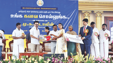 Chief Minister MK Stalin distributing a kit to a SHG field worker of the survey at an event