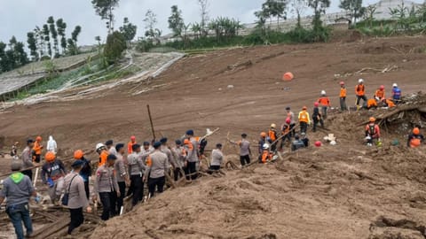 Rescuers search for victims in Pasir Langu village after a landslide, in West Bandung district of West Java province, Indonesia