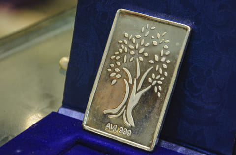 A silver bar is displayed at a bullion shop.