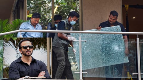 Forensic team members remove a shattered glass pane from the balcony of filmmaker Rohit Shetty