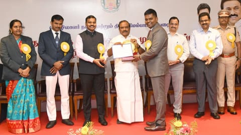 Labour Welfare Minister presenting a planque and letter of appreciation to Kishan Kumar IAS, sub-district collector, Chidambaram, for his work in rescue and rehab of bonded labourers