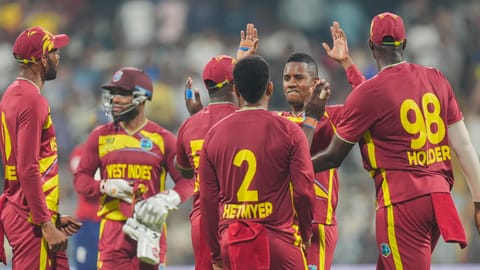 West Indies' Akeal Hosein, second right, celebrates with teammates after taking the wicket of England's Jamie Overton during an ICC Men's T20 World Cup 2026 cricket match between England and West Indies, at the Wankhede Stadium, in Mumbai, Maharashtra, Wednesday, Feb. 11, 2026