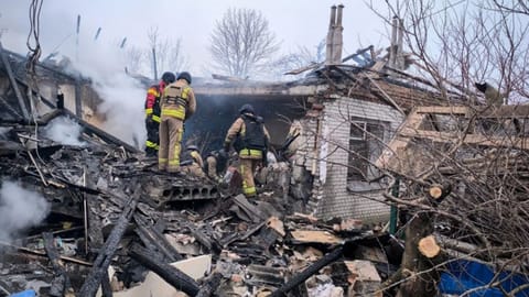 In this photo provided by the Ukrainian Emergency Service, firefighters put out the fire in private houses following a Russian air attack in Sumy region, Ukraine, Tuesday, Feb. 17, 2026.