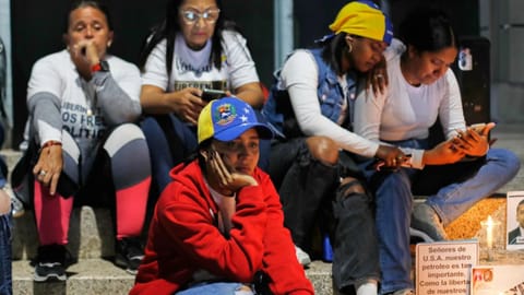 Relatives of detainees they say are held for political reasons wait outside El Helicoide, the headquarters of Venezuela's intelligence service and a detention center, after the National Assembly approved an amnesty bill in Caracas, Venezuela.