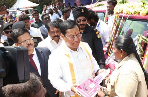 Minister for Ports, Shipping and Waterways Sarbananda Sonowal presents an auto to a fisherwoman as part of VOC Port's welfare assistance on Monday