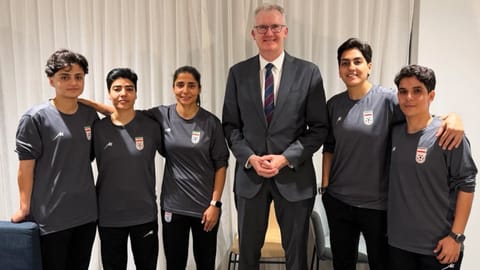 Australia’s Minister for Home Affairs Tony Burke’s office, the Minister Tony Burke, center, poses in an undisclosed location with five Iranian women soccer players who have been granted asylum in Australia.