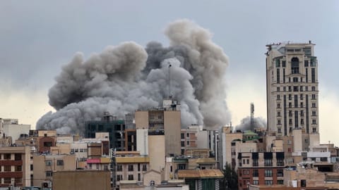 A plume of smoke rises after a strike in Tehran, Iran, Monday, March 2, 2026