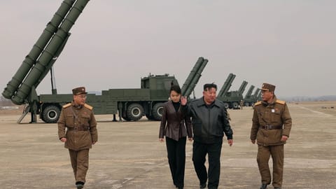 In this photo provided by the North Korean government, its leader Kim Jong Un, center right, and his daughter, center left, attend a live-fire test of multiple rocket launch systems, at an undisclosed place in North Korea Saturday, March 14, 2026.