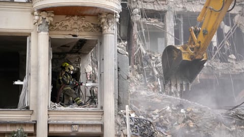 Rescue workers and first responders work at a residential building hit in an earlier U.S.-Israeli strike in Tehran, Iran