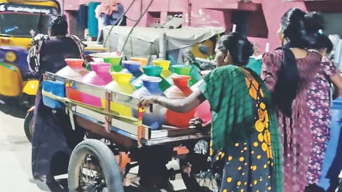 Women from Mallipoo Colony 2nd lane collect water from neighbouring streets using cart puller