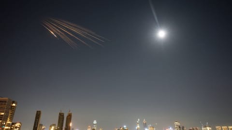 Missiles launched from Iran are seen in the sky over central Israel, Thursday, March 5, 2026