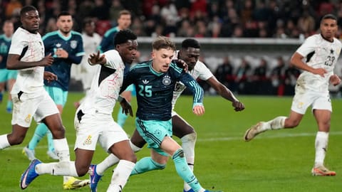 Lennart Karl of Germany and Derrick Kohn of Ghana challenge for the ball during an international friendly soccer match between Germany and Ghana in Stuttgart, Germany, Monday, March 30, 2026.