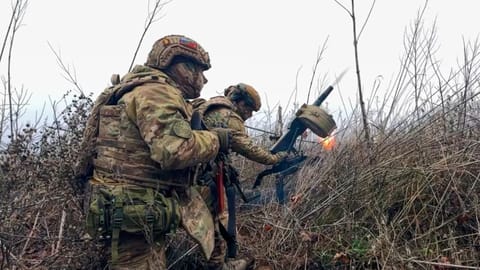 In this image made from video provided by Russian Defense Ministry Press Service on Tuesday, March 31, 2026, Russian soldiers fire a grenade launcher towards Ukrainian positions on an undisclosed location in Ukraine.