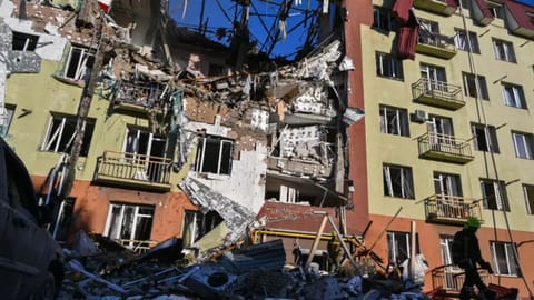 A rescue worker walks in front of residential building which was heavily damaged after a Russian strike in Odesa, Ukraine