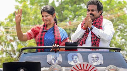 DMK Deputy General Secretary and MP Kanimozhi Karunanidhi, left, greets the gathering during an election campaign in support of the party candidate for Tiruvallur constituency, VG Raajendran, right, ahead of Tamil Nadu Assembly Election, in Tiruvallur district.