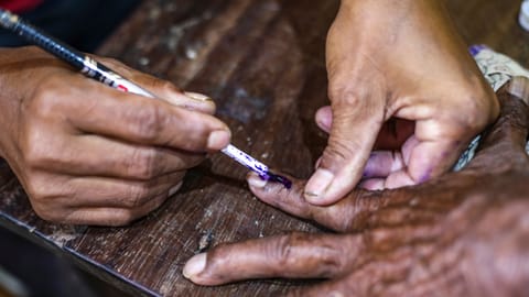 A voter gets his finger marked before casting a vote in the by-election