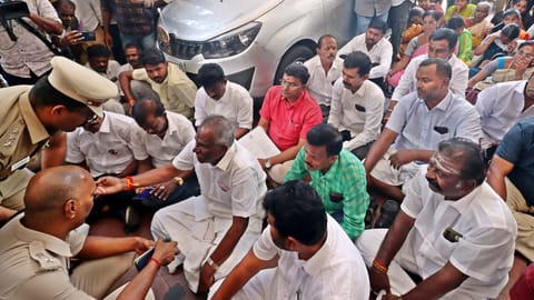 AIADMK candidate Amman K Arjunan staged a sit-in protest at district collector office.