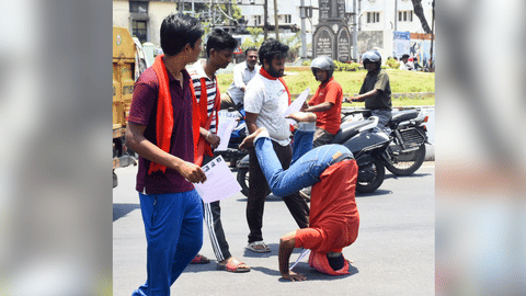 Activist Parthiban performs somersaults as he arrives to submit a petition in Salem