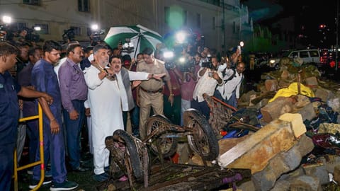 Deputy Chief Minister DK Shivakumar visits the site of a wall collapse following heavy rain, at Bowring Hospital, in Bengaluru