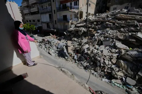 Em Ali Khodor, 75, looks through her damaged apartment hit a few weeks ago by an Israeli airstrike in Tyre, Lebanon.