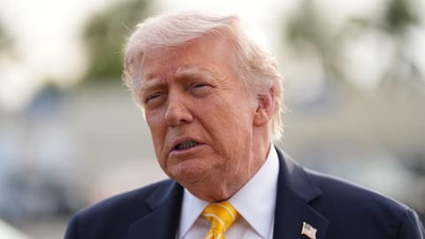 President Donald Trump talks to reporters before he boards Air Force One at Palm Beach International Airport in West Palm Beach, Fla.