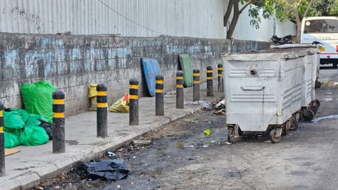 Waste in plastic bundles is seen on the footpath of Greams Road despite a garbage bin placed nearby