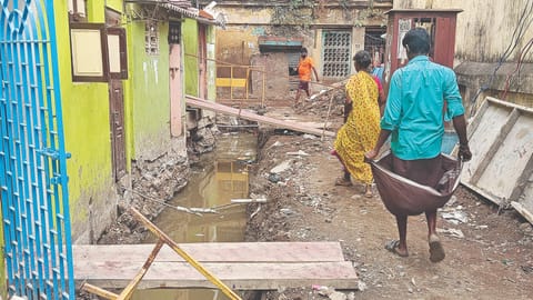 Residents of Veerasamy Street in Pulianthope walking along the open SWD on Friday