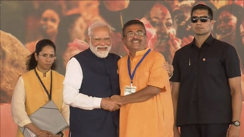 Prime Minister Narendra Modi greets newly-elected Chief Minister of West Bengal Suvendu Adhikari after the oath-taking ceremony, at Brigade Parade Ground in Kolkata