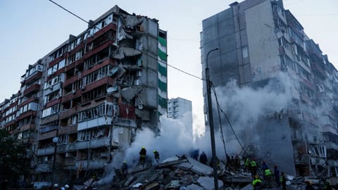Rescue workers clear the rubble of a house heavily damaged after a Russian strike on a residential neighborhood in Kyiv, Ukraine
