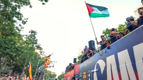Lamine Yamal holds a Palestinian flag after winning the Spanish La Liga title in Barcelona.
