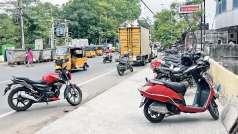 Two-wheelers parked on the pavement on City Link Road
