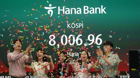 Employees of Hana Bank celebrate in a photo-op to mark the Korea Composite Stock Price Index (KOSPI) of over 8,000 points at a dealing room of Hana Bank in Seoul, South Korea, Friday, May 15, 2026.