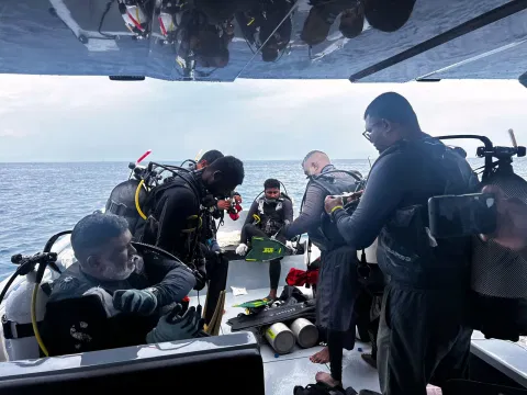 This image released by the Maldives President’s Media Division, shows divers preparing to search for the four missing Italian divers near Alimathaa Island
