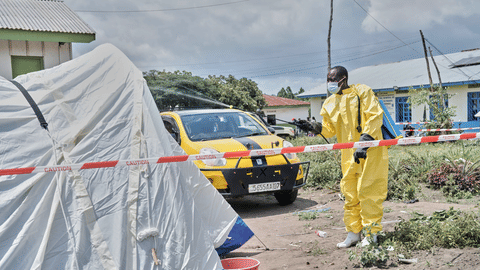 A man sprays a tent at an Ebola treatment center in Bunia
