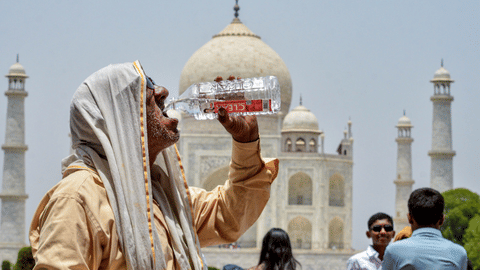 A man drinks water to quench his thirst amid scorching heat during the summer season, at Taj Mahal, in Agra, Uttar Pradesh, Saturday, May 23, 2026