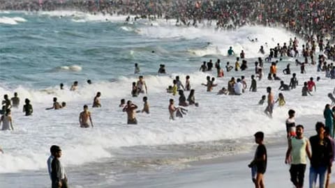 Crowds seen bathing in the sea at Marina Beac