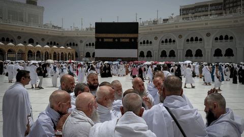 A group of Muslim pilgrims discuss the rituals of circumambulating the Kaaba, Islam’s holiest site at the Grand Mosque during the annual Hajj pilgrimage in Mecca, Saudi Arabia, Sunday, May 24, 2026.