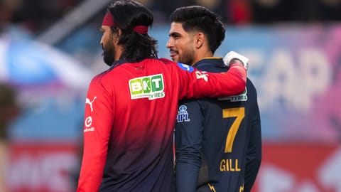 Gujarat Titans' captain Shubman Gill, right, with Royal Challengers Bengaluru's Krunal Pandya during a warm-up before the Indian Premier League (IPL) 2026 T20 first qualifier cricket match between Royal Challengers Bengaluru and Gujarat Titans