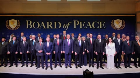 President Donald Trump stands with other World leaders before a Board of Peace meeting at the U.S. Institute of Peace