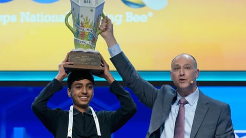 EW Scripps Company president and CEO Adam Symson, right, holds the trophy over winner of the 2026 Scripps National Spelling Bee, Shrey Parikh, 14, of Rancho Cucamonga