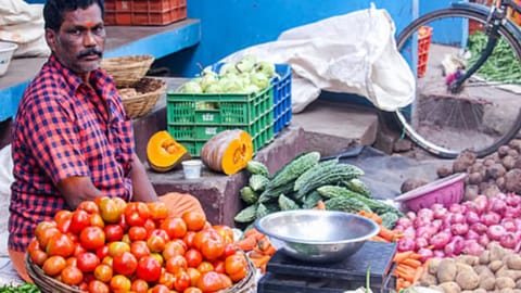 Image of man selling vegetables used for representative image