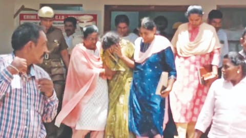 Krishnakumari being escorted outside the CB-CID office