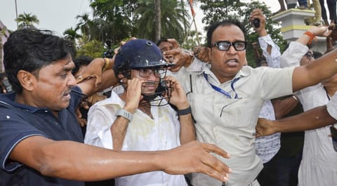 TMC General Secretary Abhishek Banerjee wears a helmet after stones, shoes and eggs were hurled at him during his visit to meet families of post-poll violence victims, in Sonarpur, West Bengal