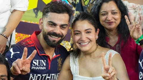 Royal Challengers Bengaluru's Virat Kohli, left, celebrates with his wife and actor Anushka Sharma, front right, and others after winning the Indian Premier League (IPL) 2026 title, in Ahmedabad, Gujarat