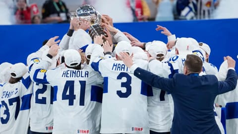 Finland players celebrate with trophy after winning the 2026 IIHF Men's Ice Hockey World Championship final match against Switzerland, in Zurich